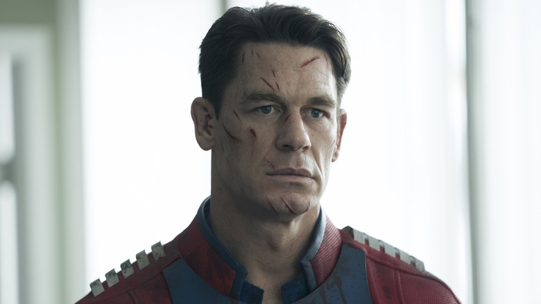 Peacemaker with his face covered in cuts in "Peacemaker."