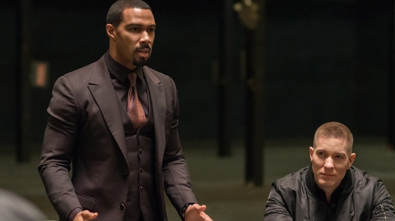 Ghost stands and talks as Tommy sits and listens in "Power" (2014-2020)