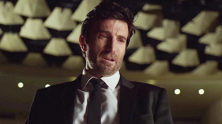 Christian Walker wearing a suit in "Powers."
