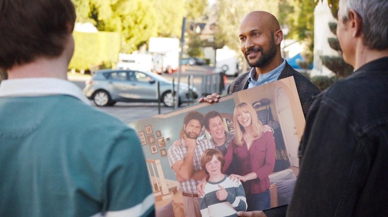 Reed holding a press photo of Step Right Up on Reboot