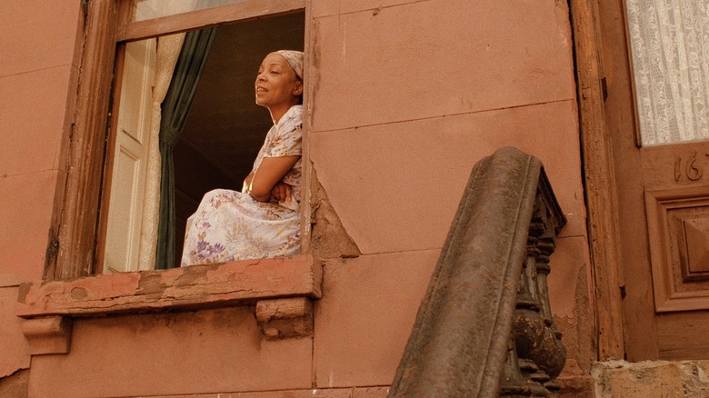 Mother Sister observing the neighborhood from her window