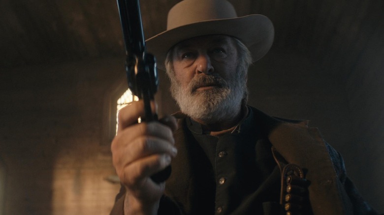 Harland Rust holds a gun in "Rust" (2024)