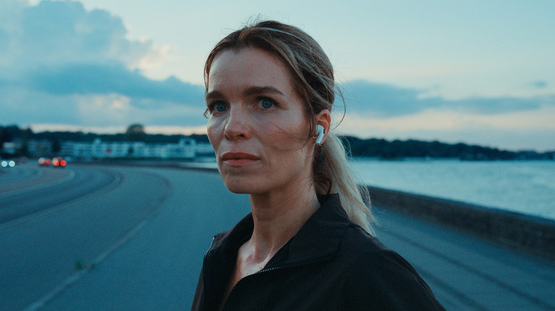 Cecilie standing by water in "Secrets We Keep."