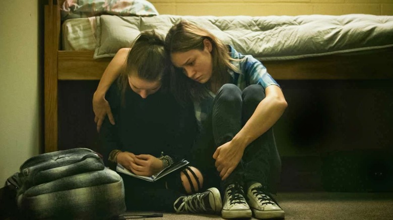 Grace puts her arm around Jayden sitting by a bed in "Short Term 12" (2013)