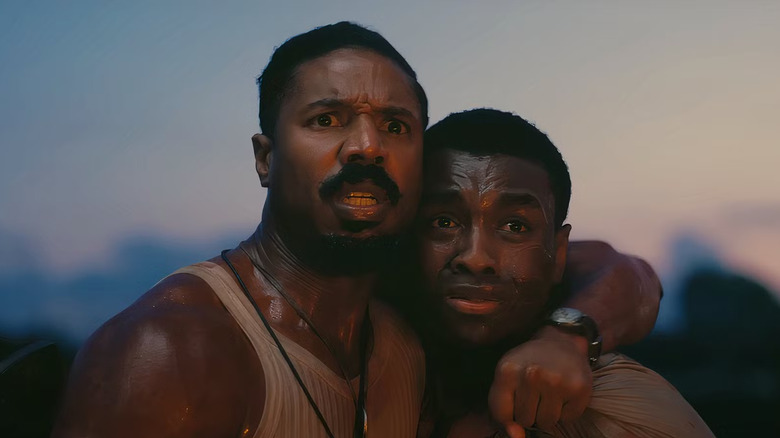 Smoke puts his arm around Sammie's neck in "Sinners" (2025)