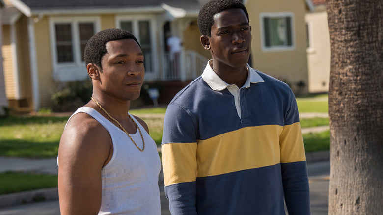 Kevin and Franklin stand outside in "Snowfall" (2017-2023))