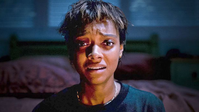 Mia gives a distraught look in a dark room in "Talk to Me" (2022)