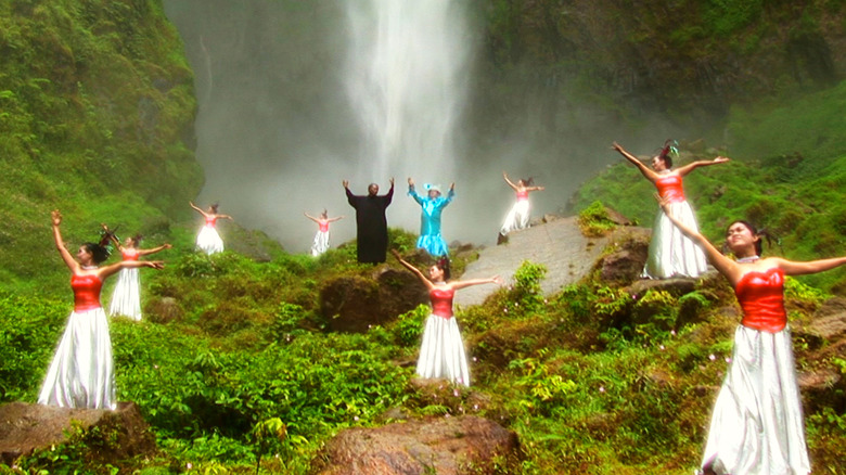People dance in front of a waterfall in "The Act of Killing" (2012)