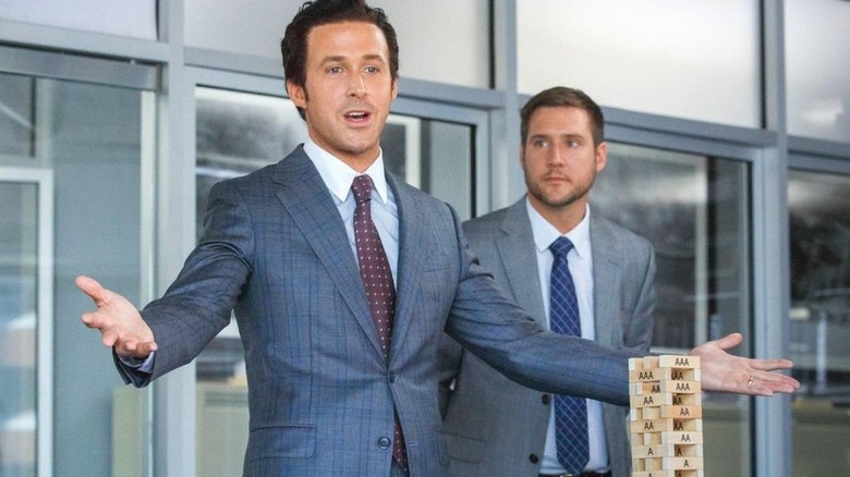 Jared in a suit in front of a Jenga-like game in The Big Short (2015)