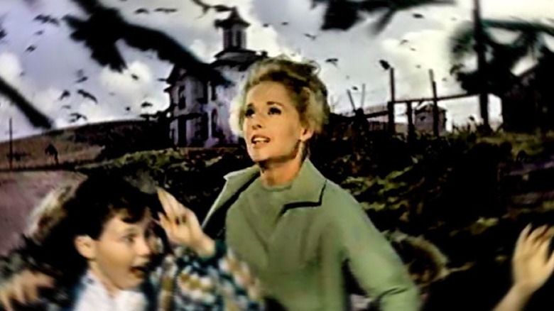 Melanie Daniels and children flee attacking crows in "The Birds" (1963)