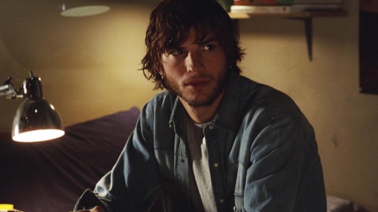Evan sits on his bed