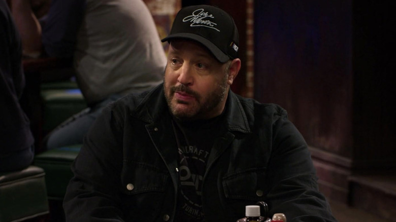 Kevin Gibson wearing a baseball cap in a restaurant
