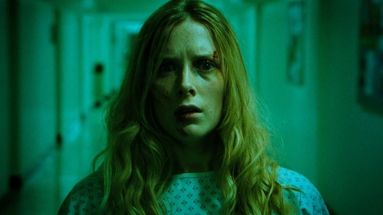 Sarah stares into the camera with a terrified expression in "The Descent" (2005)