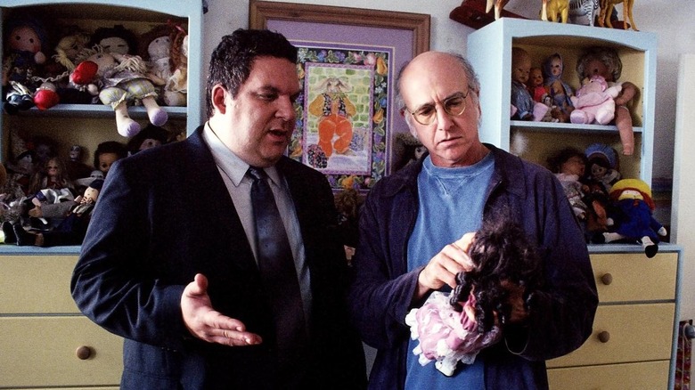 Larry and Jeff examine a doll in "The Doll"