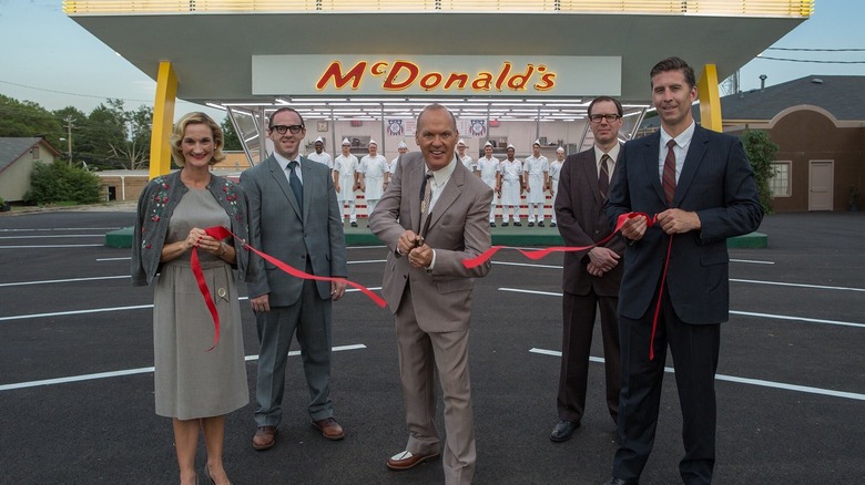 Michael Keaton as Ray Kroc cutting a ribbon in The Founder (2016)