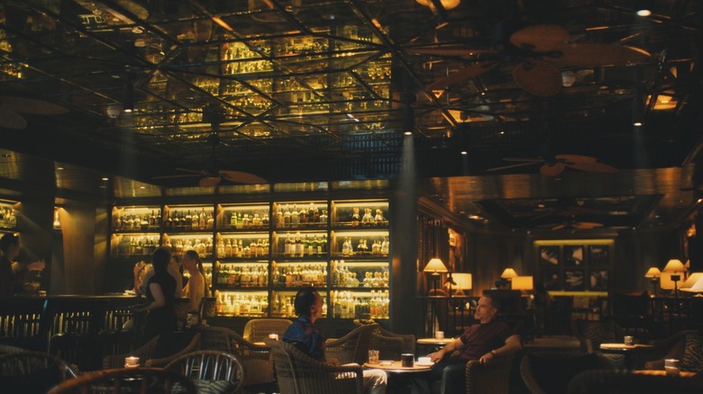 Rick and Frank talking in a bar in "The White Lotus"