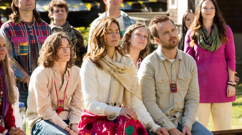 A group of people sitting on benches in "The Path."