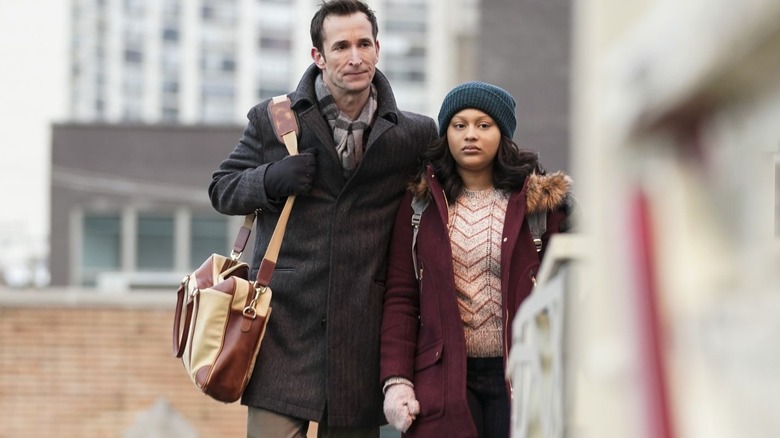 Daniel and Jira walking on a train platform in "The Red Line" (2019)