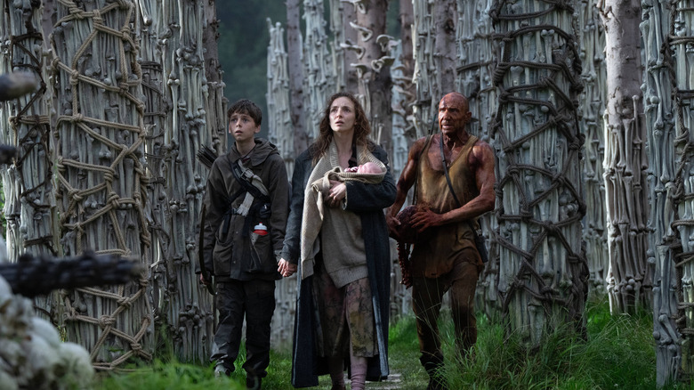 Spike, Isla, and Dr. Kelson taking in his towers of bones