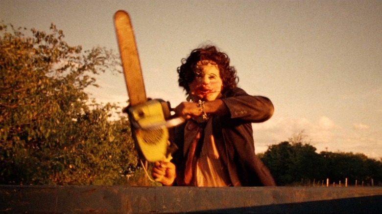 Leatherface holds a chainsaw in "The Texas Chain Saw Massacre" (1974)