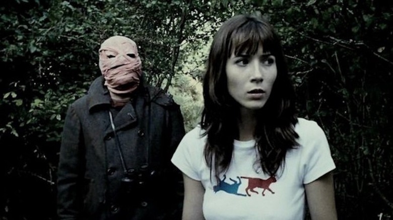 The bandaged man stands ominously behind Clara in the woods in "Timecrimes" (2007)