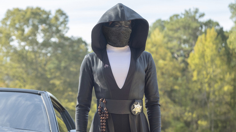 Sister Night standing outside by her car in "Watchmen."