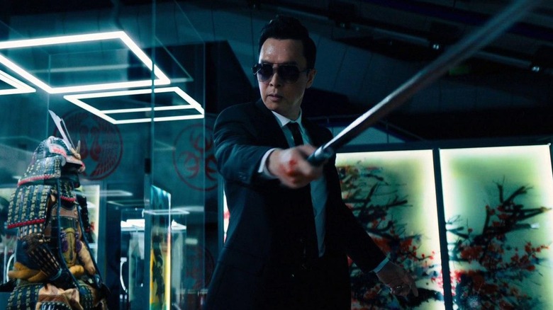 Caine holds his sword in the museum gallery in "John Wick: Chapter 4" (2023)