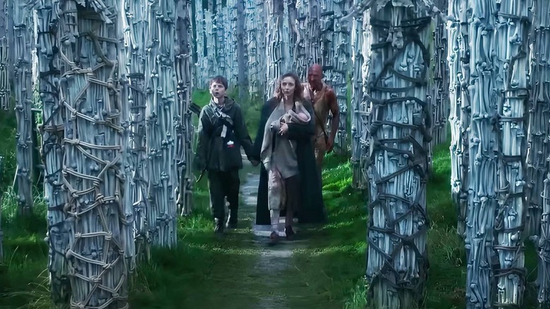 Spike, Isla, and Dr. Kelson walking through bone pillars in 28 Years Later