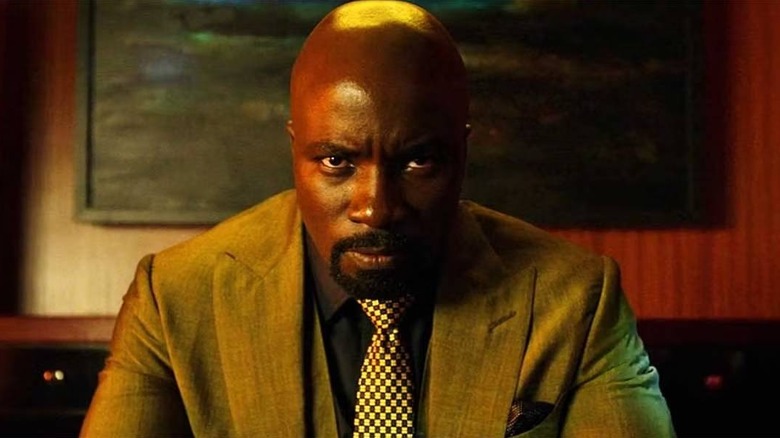 Luke Cage sitting forward at his desk
