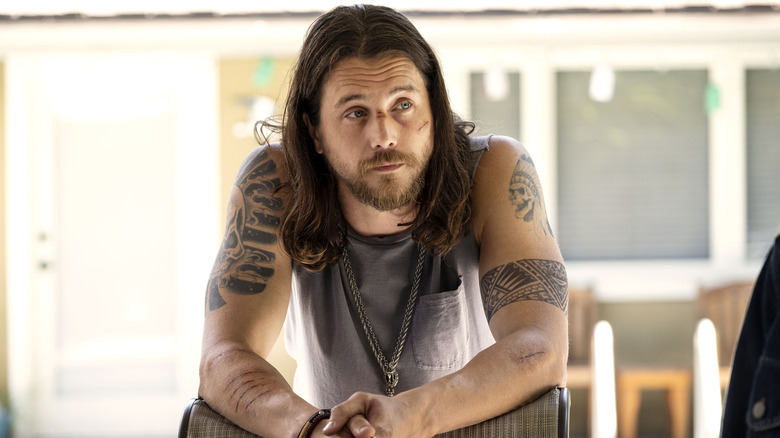 Craig with a cut face leaning on a chair in "Animal Kingdom"