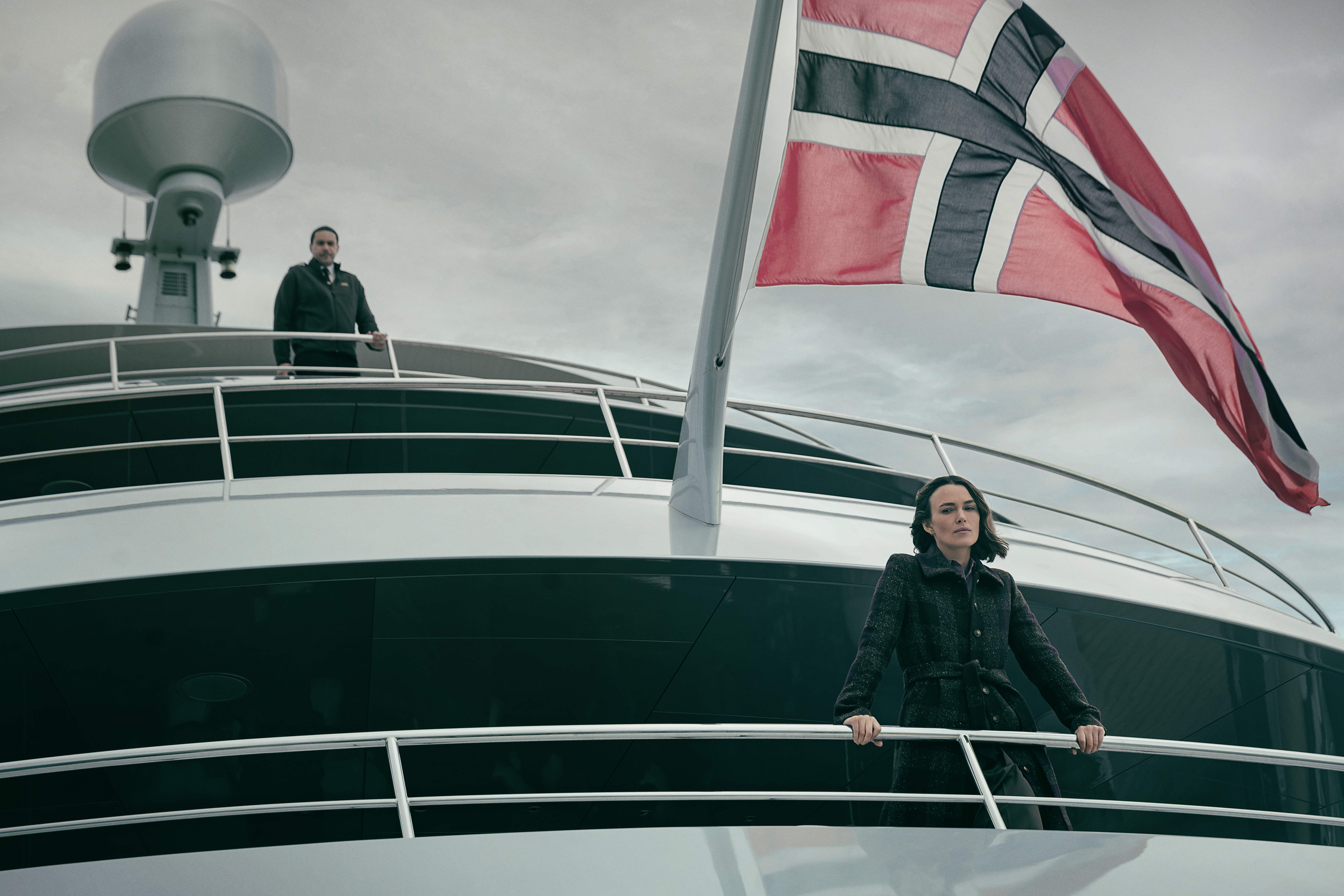 The Woman in Cabin 10. (L-R) Keira Knightley as Lo and John Macmillan as Captain Addis in The Woman in Cabin 10. Cr. Parisa Taghizadeh/Netflix © 2025