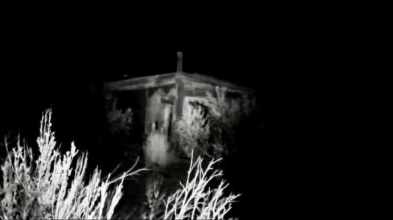 The exterior of the remote cabin, seen at night, in "Horror in the High Desert" (2021)