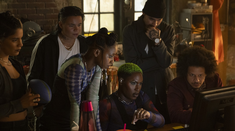 Roz, Jeri, Clown, Slug, John, and Rampage standing around computer in "Ironheart" (2025)