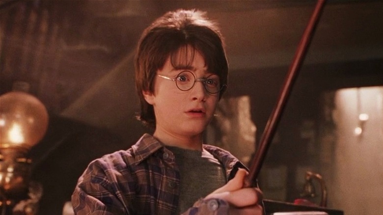 Harry Potter holds his wand in "Harry Potter and the Sorcerer's Stone" (2001)