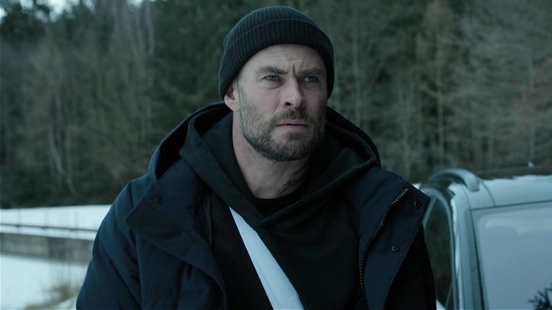 Tyler Rake standing in the snow in "Extraction 2" (2023)