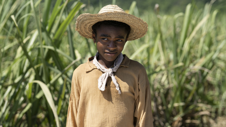 Young Wash wearing a hat in a field outside
