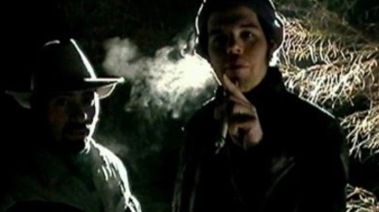 Two men stand near each other in the woods in "The Last Broadcast" (1998)