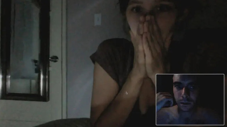 Emily covers her mouth in fear on a Zoom call with James in "V/H/S" (2012)