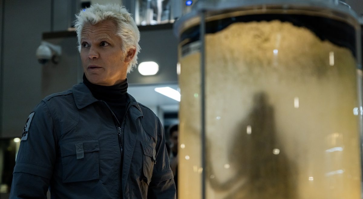 'Alien: Earth' stars Timothy Olyphant as Kirsh, shown here standing near a container with an alien inside
