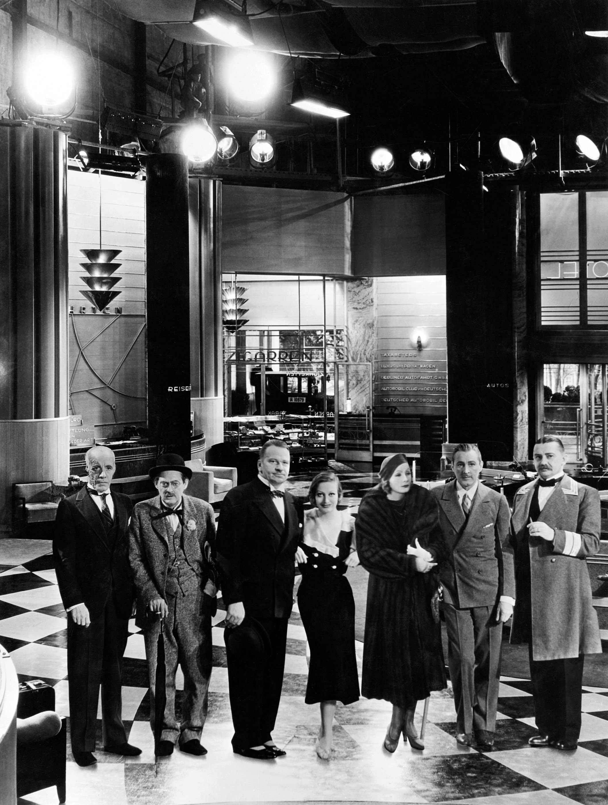 GRAND HOTEL, from left: Lewis Stone, Lionel Barrymore, Wallace Beery, Joan Crawford, a cardboard cutout of Greta Garbo, John Barrymore, Jean Hersholt, on set, 1932