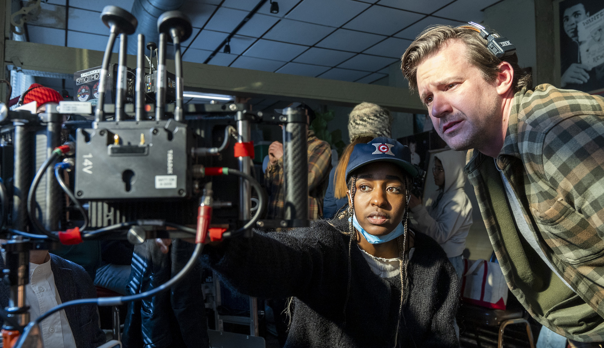 Actor Ayo Edebiri pointing at a monitor while directing 'The Bear'