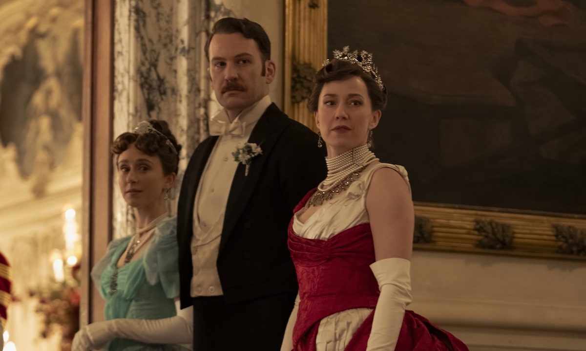 'The Gilded Age' Season 3 Episode 8 stars Taissa Farmiga as Gladys, Ben Lamb as the Duke, and Carrie Coon as Bertha Russell, shown standing in a line, waiting to greet guests, super fancy