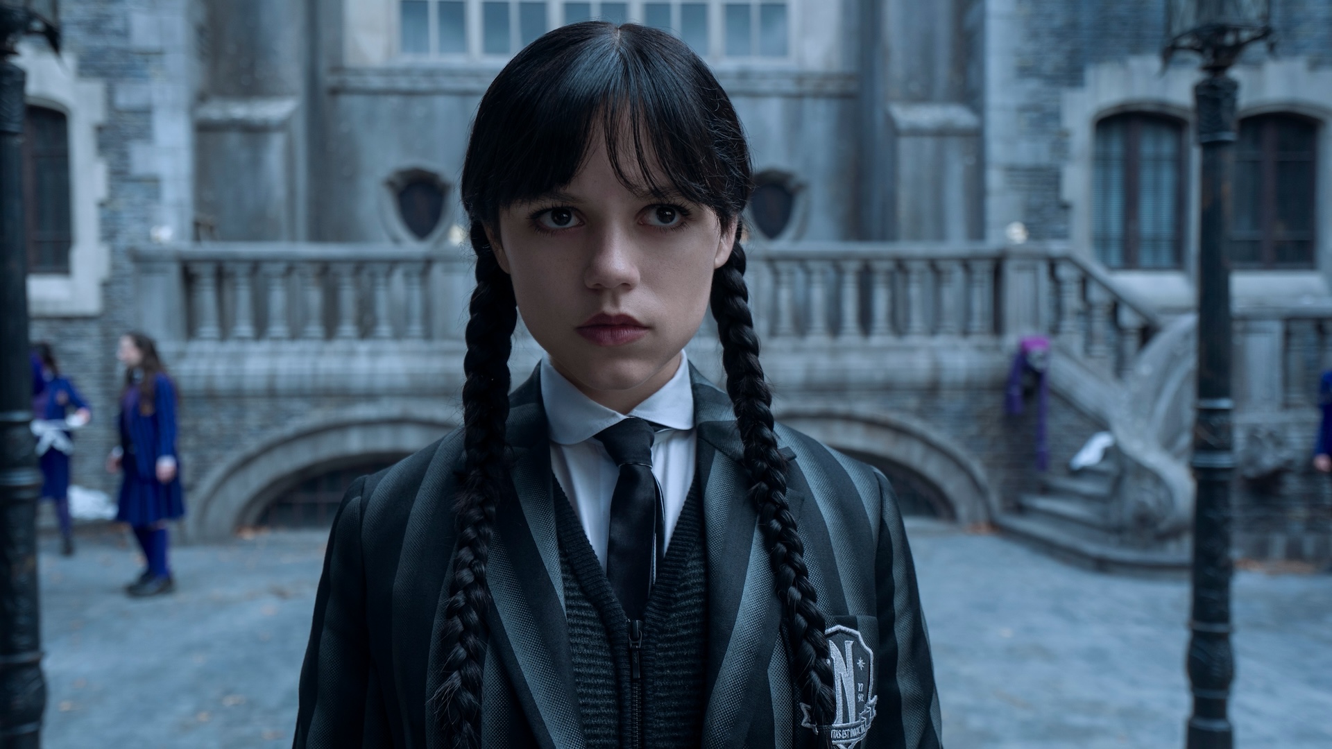 A teen girl with long black hair in two braids; Jenna Ortega in and as 'Wednesday'