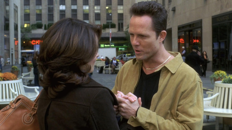 Dennis holding Liz Lemon's hand in 30 Rock