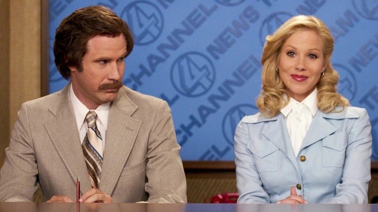 Ron looks at Veronica as both sit behind a news desk in Anchorman (2004)
