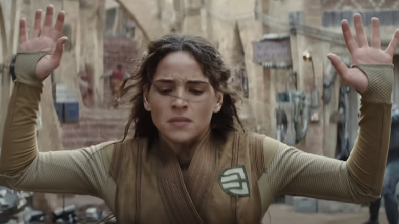Bix (Adria Arjona) getting caught and held up by Empire forces