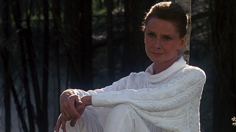 Hap glares while leaning on a tree in "Always" (1989)