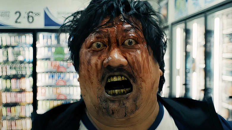 bloodied bug-eyed Marcus runs screaming in a store in "Weapons" (2025)