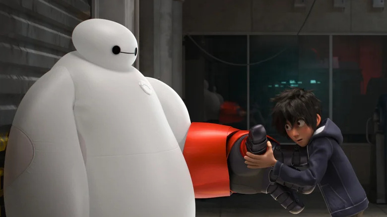Hiro pulls a glove off Baymax in Big Hero 6 (2014)