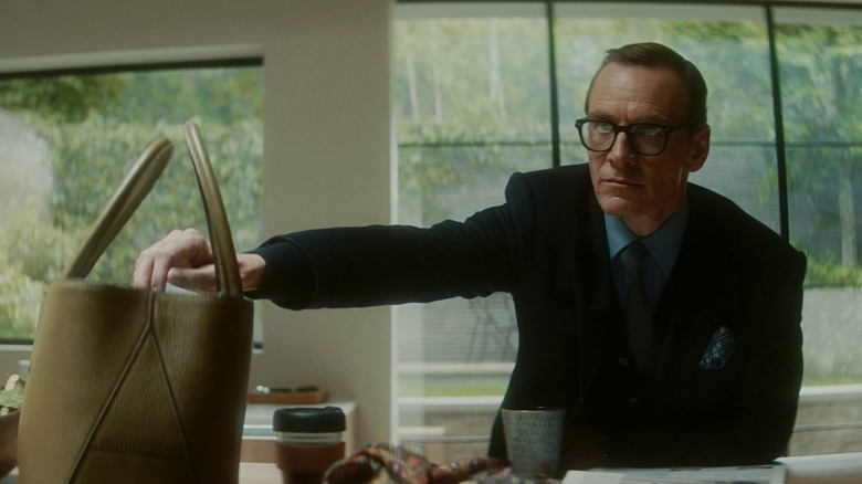 Woodhouse sits at his desk looking ominously towards the door in Black Bag (2025)
